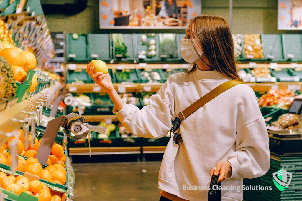 Staying Clean While Staying Open Woman wears a mask for health and safety while shopping for groceries