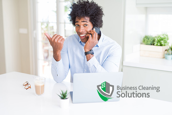 Cover-image Man smiles while on the phone giving feedback to his commercial cleaning company.