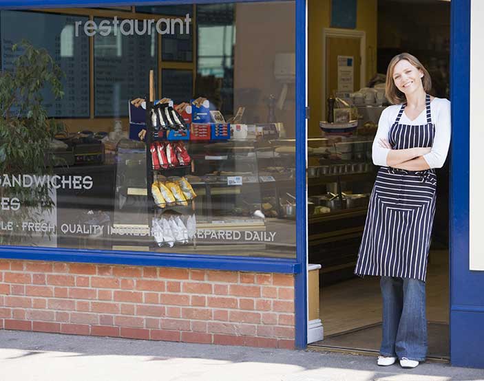 Business owner proud of clean storefront.