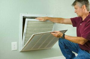 Man changing out the HVAC Air filter.
