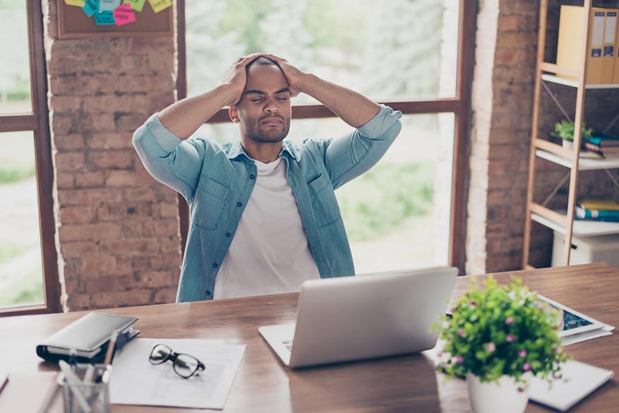 man feels ill while suffering sick building syndrome