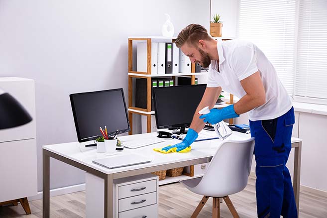 professional janitor following a checklist for office cleaning.