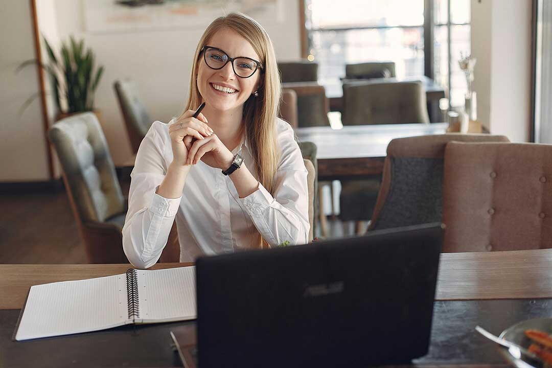 A happy business owner working in a clean office.